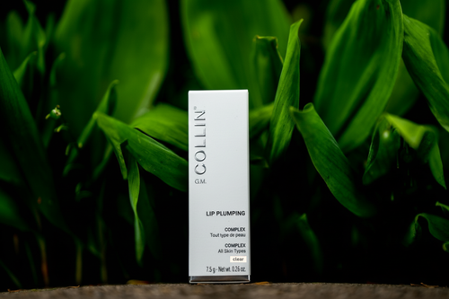 GM Collin Lip Plumping Complex in a box, colour clear, on a dark leafy background.