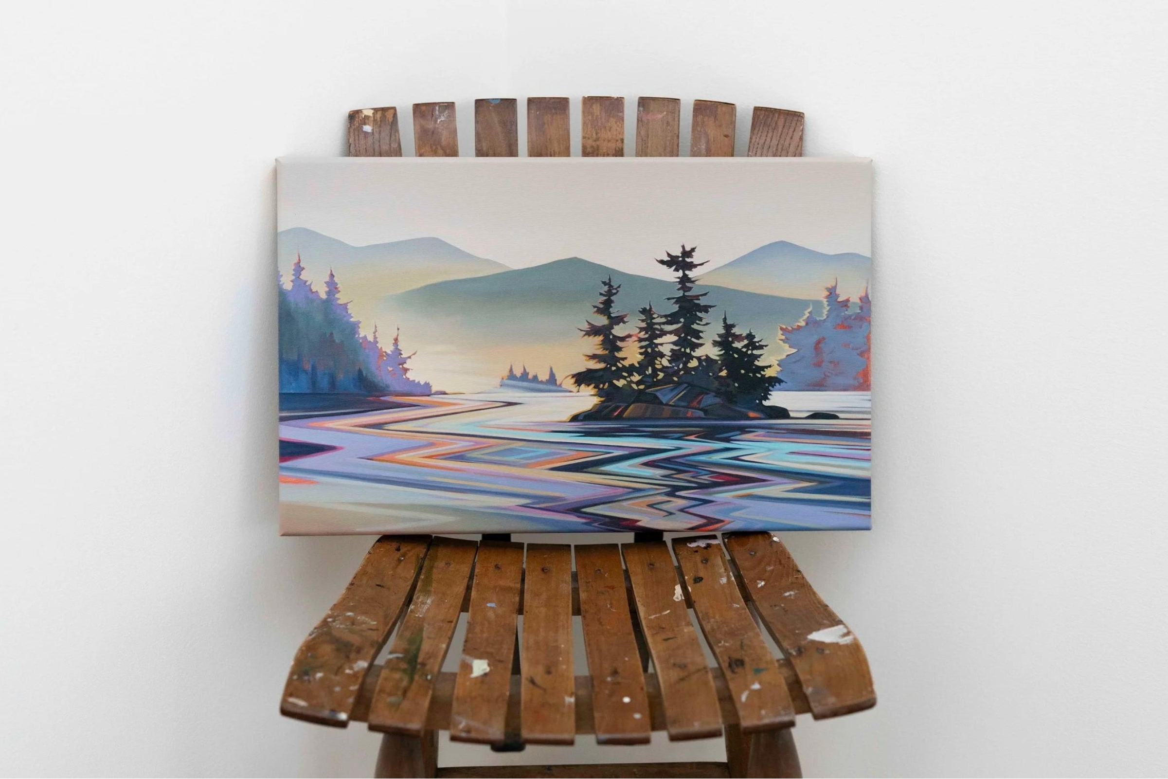 Fiona Dalrymple painting, "Spectrum", sitting on a wooden painter's chair, with a white background.