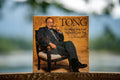 Book titled 'Tong: The Story of Tong Louie, Vancouver's Quiet Titan' with a portrait on the cover.