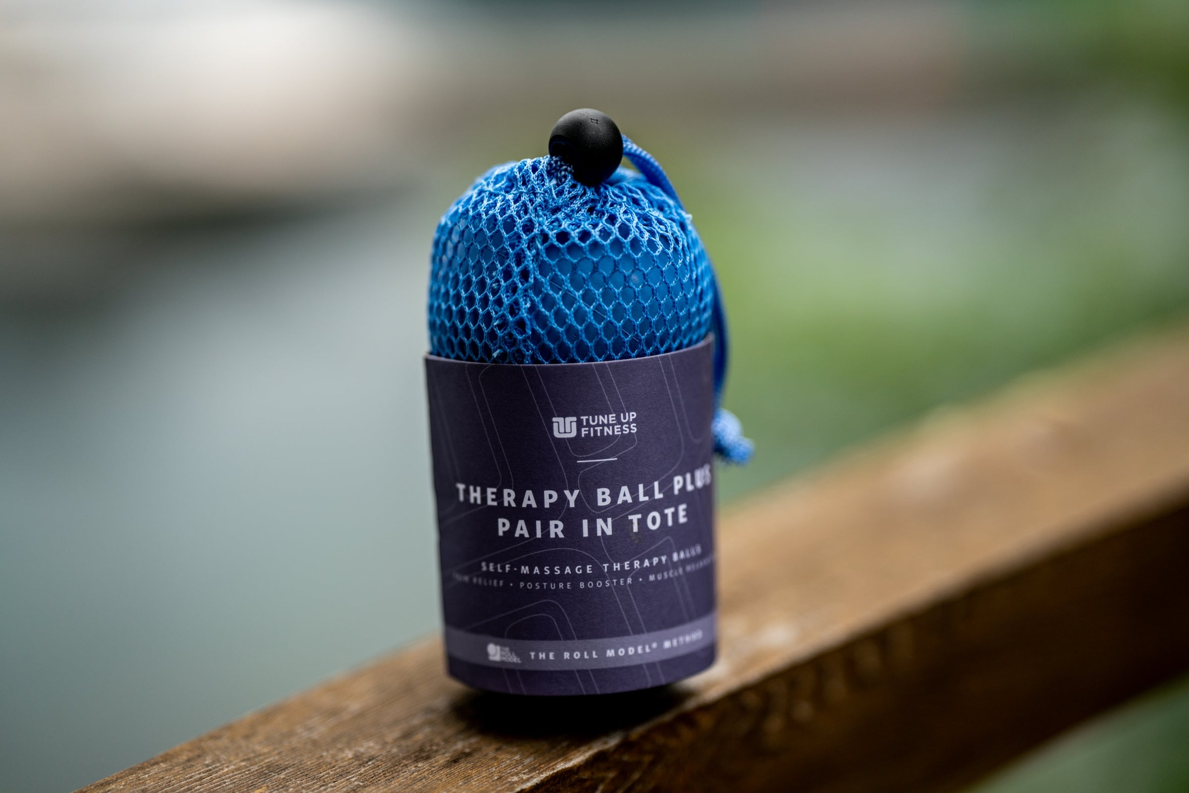 Blue therapy ball with purple label on a wooden surface