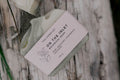 The Hobbyist On The Inlet Botanical Soap. Mint, Rosemary, Cedarwood, Lavender. 145g. on a wood surface.